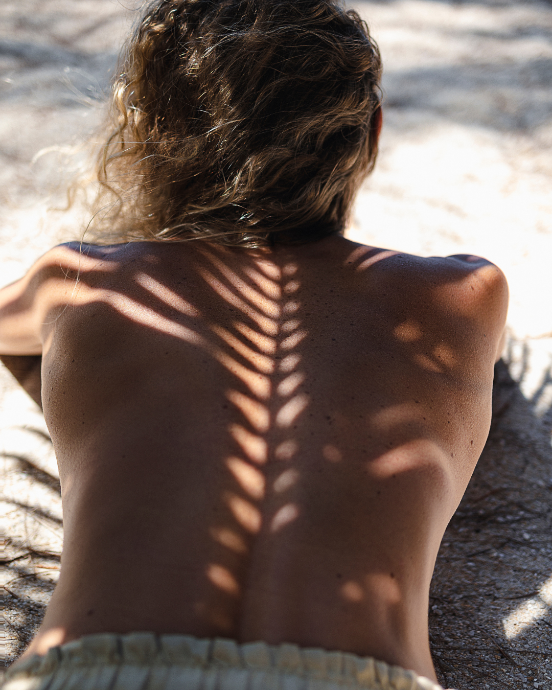 Bronzed skin with soft palm shadows